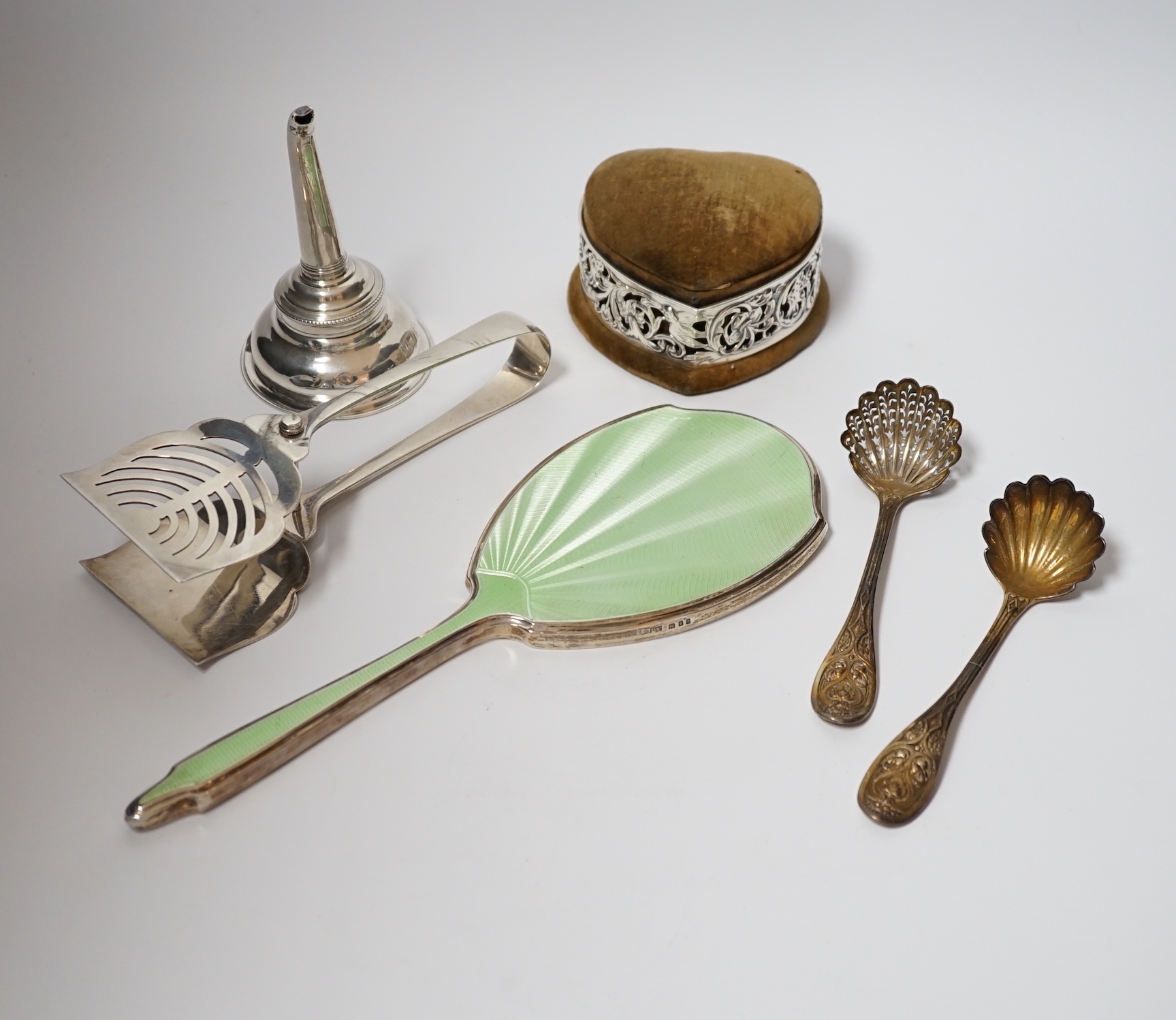 A Georgian silver wine funnel, 11.7cm (a.f.), a pair of silver servers, a pair of Victorian silver sifter spoons, George Adams, London, 1859, a silver and enamel mounted hand mirror and a George V pierced silver mounted